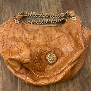 Antonio Melani brown purse with heavy gold straps and accents